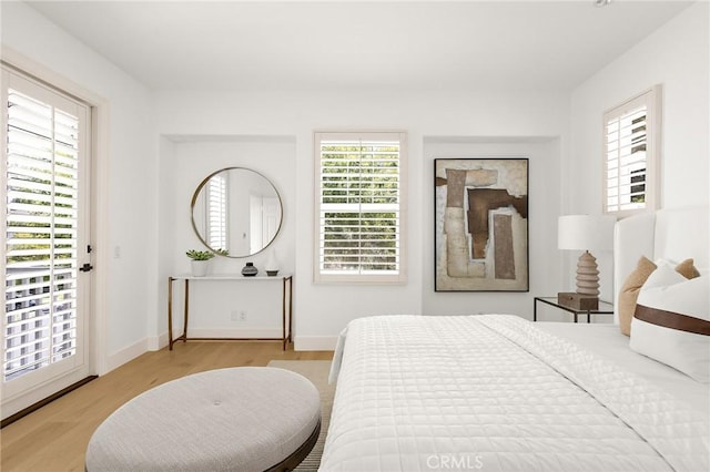 3 Seabluff, Newport Beach, CA 92660 - bedroom with wood finished floors, multiple windows, and access to outside