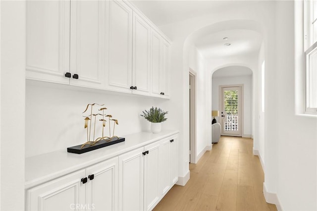 3 Seabluff, Newport Beach, CA 92660 - corridor featuring arched walkways and light wood finished floors