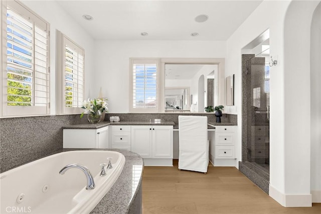 3 Seabluff, Newport Beach, CA 92660 - full bath with vanity, a jetted tub, a shower stall, and wood finished floors