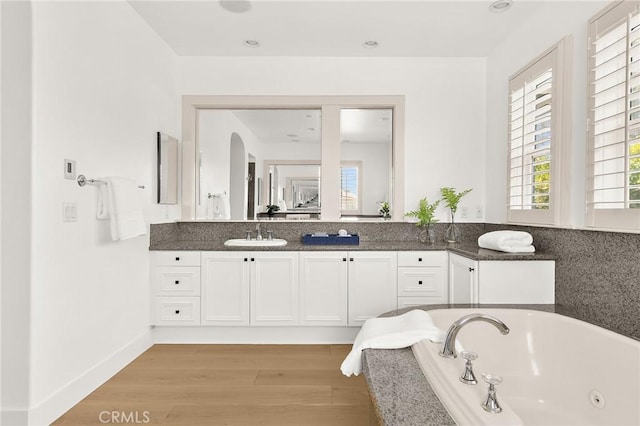 3 Seabluff, Newport Beach, CA 92660 - bathroom with a whirlpool tub, double vanity, and wood finished floors