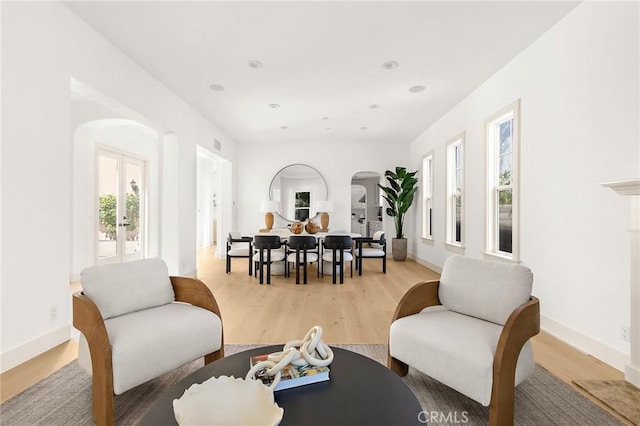 3 Seabluff, Newport Beach, CA 92660 - living room with arched walkways, french doors, light wood-style floors, and recessed lighting