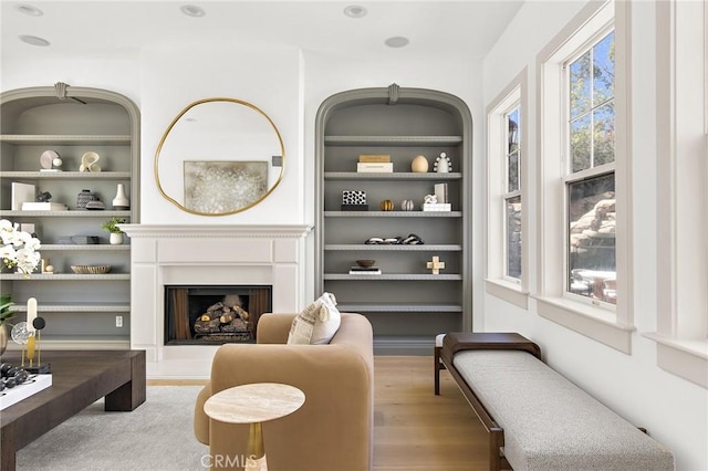 3 Seabluff, Newport Beach, CA 92660 - living area with wood finished floors, built in shelves, and a fireplace with raised hearth