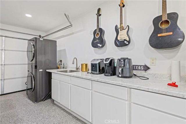 7417 Ponce Ave, West Hills, CA 91307 - bar area featuring stacked washer / dryer, a sink, and dark speckled floor