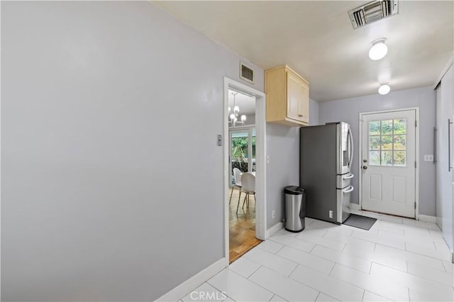 7417 Ponce Ave, West Hills, CA 91307 - kitchen with stainless steel fridge, light brown cabinets, and baseboards