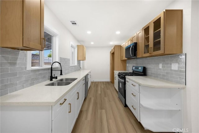 9737 Felipe Ave, Montclair, CA 91763 - kitchen with stainless steel appliances, light wood-type flooring, open shelves, glass insert cabinets, and backsplash