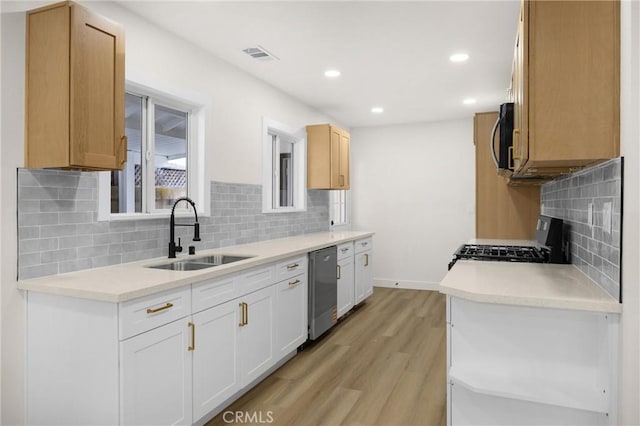9737 Felipe Ave, Montclair, CA 91763 - kitchen with stove, black microwave, stainless steel dishwasher, decorative backsplash, and light wood-type flooring
