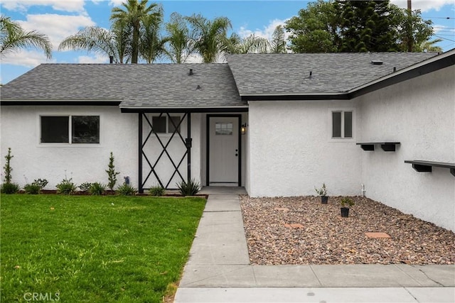 9737 Felipe Ave, Montclair, CA 91763 - view of front facade with roof with shingles, stucco siding, and a front yard