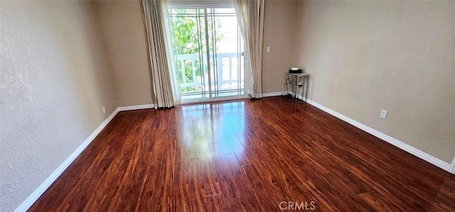 9715 Raven Cir, Fountain Valley, CA 92708 - unfurnished room with a textured wall, baseboards, and dark wood-style floors