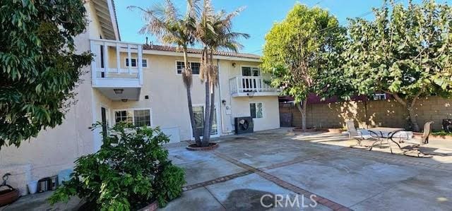 9715 Raven Cir, Fountain Valley, CA 92708 - back of house featuring a patio area, stucco siding, and a balcony