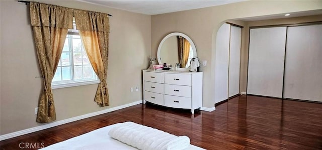 9715 Raven Cir, Fountain Valley, CA 92708 - bedroom with wood finished floors, arched walkways, baseboards, and a closet