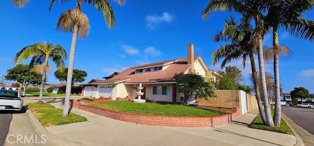 9715 Raven Cir, Fountain Valley, CA 92708 - view of front facade with an attached garage and a front yard