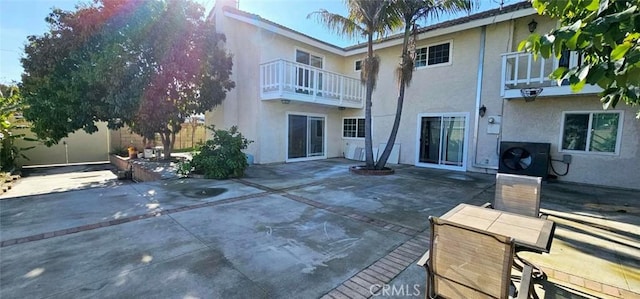 9715 Raven Cir, Fountain Valley, CA 92708 - rear view of property featuring a balcony, stucco siding, and a patio area