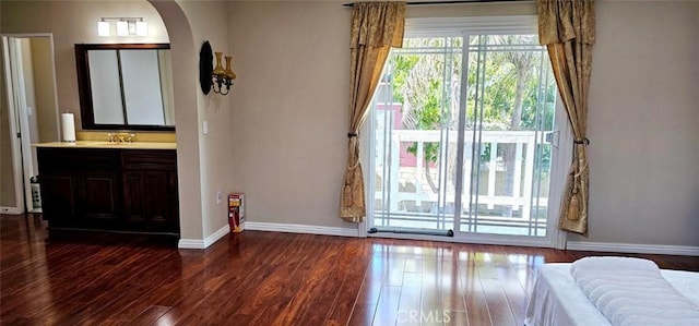 9715 Raven Cir, Fountain Valley, CA 92708 - bedroom with dark wood finished floors, arched walkways, baseboards, and a sink