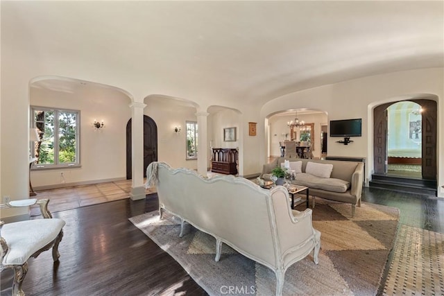 3492 Circle Rd, San Bernardino, CA 92405 - living area featuring arched walkways, wood finished floors, ornate columns, and a chandelier
