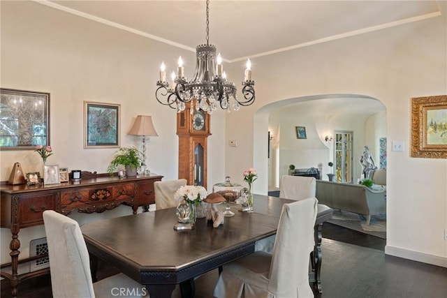 3492 Circle Rd, San Bernardino, CA 92405 - dining area with arched walkways, a chandelier, wood finished floors, and baseboards