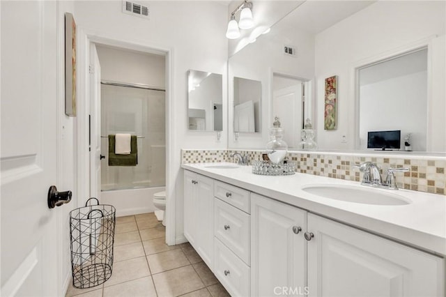 6038 Grace St, Chino, CA 91710 - bathroom with toilet, double vanity, tile patterned floors, combined bath / shower with glass door, and backsplash