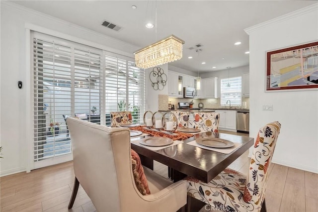 6038 Grace St, Chino, CA 91710 - dining area featuring light wood-style floors, baseboards, recessed lighting, a chandelier, and crown molding