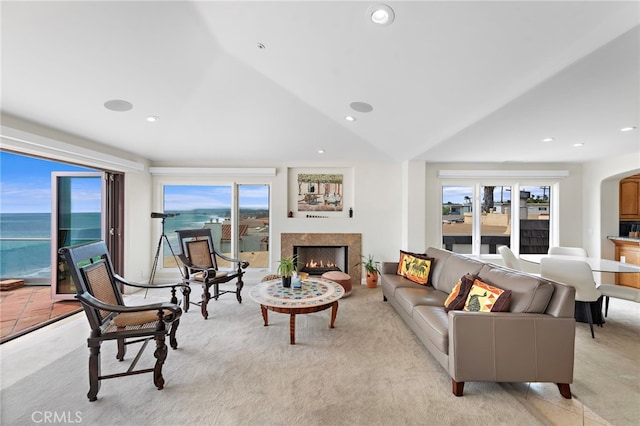 911 Buena Vis Unit 1, San Clemente, CA 92672 - living room with a warm lit fireplace, healthy amount of natural light, vaulted ceiling, light colored carpet, and recessed lighting