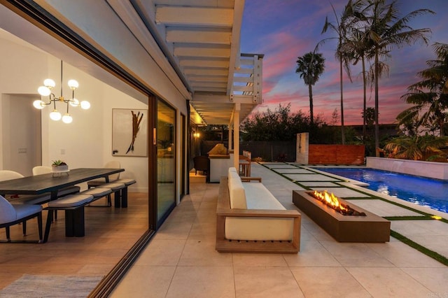 1368 Hymettus Ave, Encinitas, CA 92024 - pool at dusk with an outdoor fire pit, a patio, and outdoor dining space