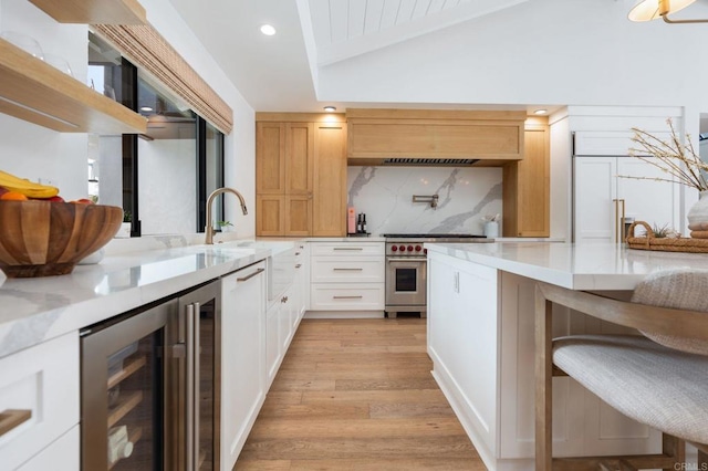 1368 Hymettus Ave, Encinitas, CA 92024 - kitchen featuring designer range, wine cooler, light wood-style flooring, tasteful backsplash, and recessed lighting