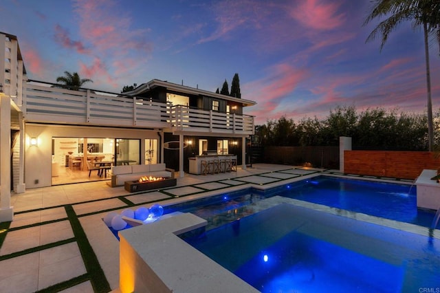 1368 Hymettus Ave, Encinitas, CA 92024 - pool at dusk with an in-ground hot tub, an outdoor fire pit, and a patio area