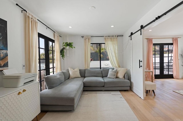 1368 Hymettus Ave, Encinitas, CA 92024 - living area with french doors, light wood finished floors, plenty of natural light, a barn door, and recessed lighting
