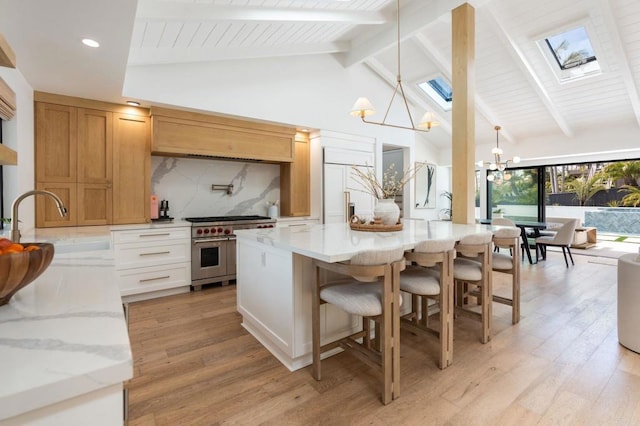 1368 Hymettus Ave, Encinitas, CA 92024 - kitchen featuring high quality appliances, a skylight, a chandelier, light wood-style flooring, and beamed ceiling