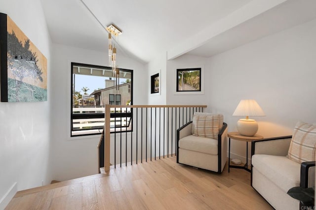 1368 Hymettus Ave, Encinitas, CA 92024 - living area featuring an upstairs landing, wood finished floors, and vaulted ceiling