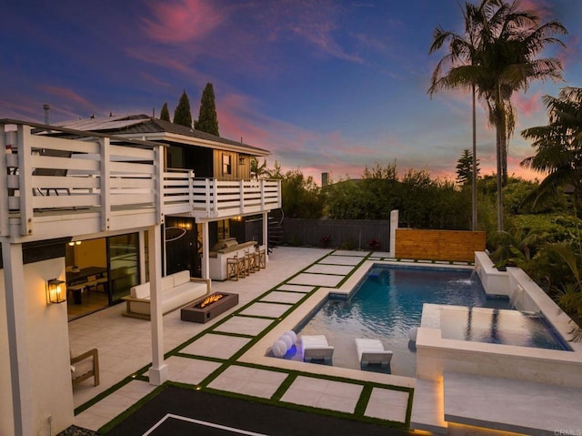 1368 Hymettus Ave, Encinitas, CA 92024 - pool at dusk featuring an outdoor fire pit, an in-ground hot tub, and a patio area