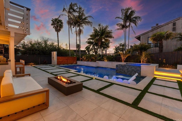 1368 Hymettus Ave, Encinitas, CA 92024 - pool at dusk featuring a fire pit, a patio, a pool with connected hot tub, and a fenced backyard
