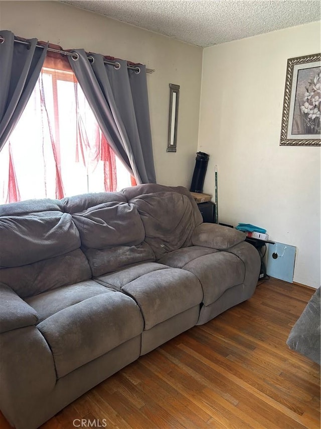 2650 E Jefferson St, Carson, CA 90810 - living area with wood finished floors and a textured ceiling