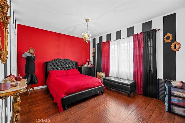 16900 Mayall St, North Hills, CA 91343 - bedroom with an accent wall, hardwood / wood-style floors, and a chandelier