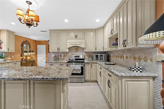 16900 Mayall St, North Hills, CA 91343 - kitchen featuring cream cabinets, stainless steel gas stove, custom exhaust hood, decorative backsplash, and recessed lighting