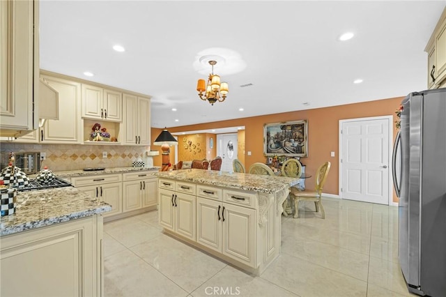 16900 Mayall St, North Hills, CA 91343 - kitchen featuring cream cabinetry, stainless steel appliances, a chandelier, light stone countertops, and recessed lighting
