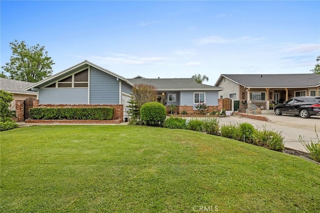 16900 Mayall St, North Hills, CA 91343 - view of front of home with brick siding, a front yard, and a garage