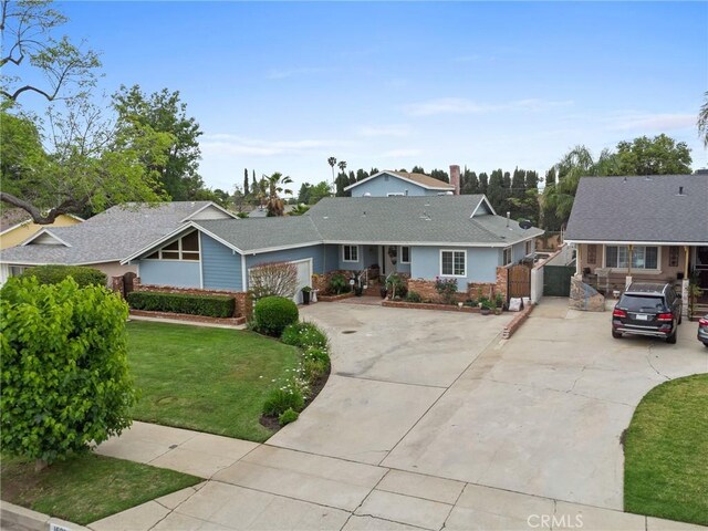 16900 Mayall St, North Hills, CA 91343 - ranch-style house with driveway, brick siding, and a gate