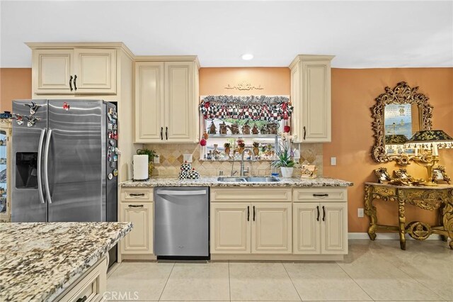 16900 Mayall St, North Hills, CA 91343 - kitchen with appliances with stainless steel finishes, a sink, cream cabinets, backsplash, and recessed lighting