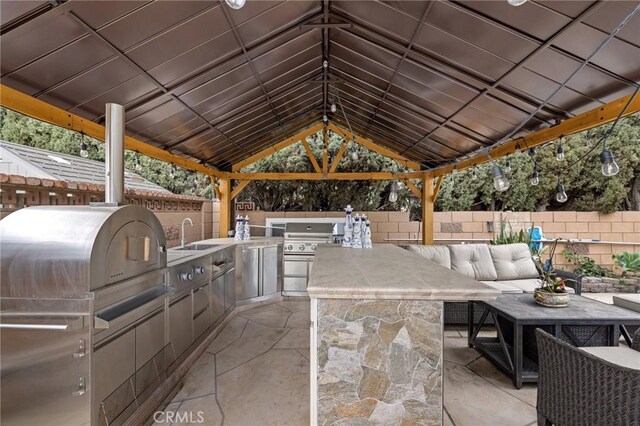 16900 Mayall St, North Hills, CA 91343 - fenced backyard with a sink, an outdoor hangout area, a patio area, and a gazebo