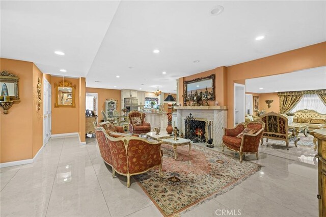 16900 Mayall St, North Hills, CA 91343 - living room with a lit fireplace, recessed lighting, baseboards, and light tile patterned floors