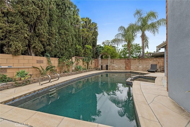 16900 Mayall St, North Hills, CA 91343 - view of swimming pool with a fenced backyard, a pool with connected hot tub, a patio area, and a sink
