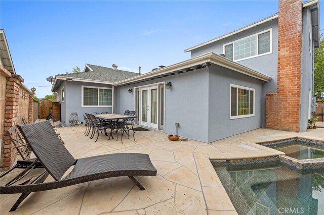 16900 Mayall St, North Hills, CA 91343 - rear view of property featuring stucco siding, a patio area, a fenced backyard, french doors, and an in-ground hot tub