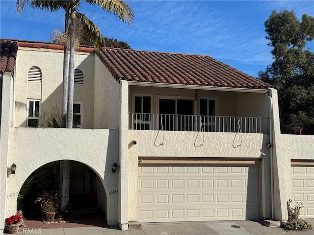 30724 Calle Resplendor, San Juan Capistrano, CA 92675 - view of front of home featuring a balcony, stucco siding, a tile roof, and a garage