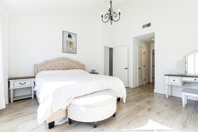 11911 Magnolia Blvd Unit 19, Valley Village, CA 91607 - bedroom with a chandelier, light wood-style floors, high vaulted ceiling, and baseboards