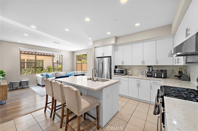 107 Tubeflower, Irvine, CA 92618 - kitchen with appliances with stainless steel finishes, range hood, a kitchen bar, a sink, and open floor plan