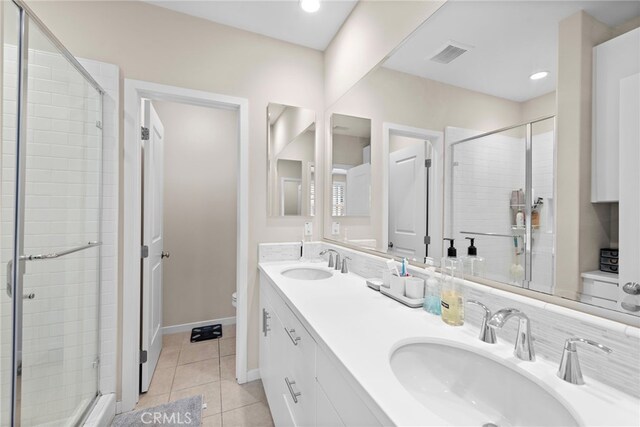 107 Tubeflower, Irvine, CA 92618 - full bathroom featuring toilet, a stall shower, double vanity, tile patterned flooring, and recessed lighting