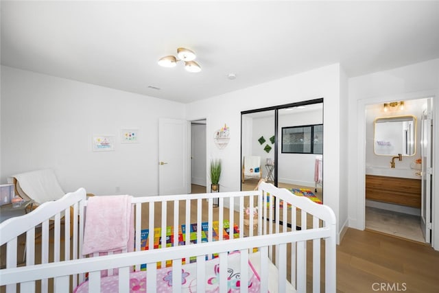 3209 Lakeknoll Dr, Fullerton, CA 92835 - bedroom featuring wood finished floors, a closet, and a nursery area