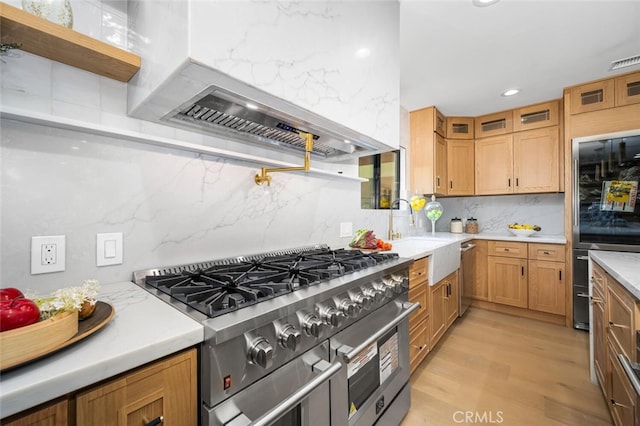 3209 Lakeknoll Dr, Fullerton, CA 92835 - kitchen featuring stainless steel appliances, ventilation hood, backsplash, light wood finished floors, and light countertops