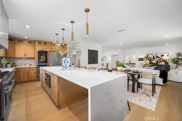 3209 Lakeknoll Dr, Fullerton, CA 92835 - kitchen featuring stainless steel appliances, open floor plan, light wood-style floors, a kitchen island, and recessed lighting
