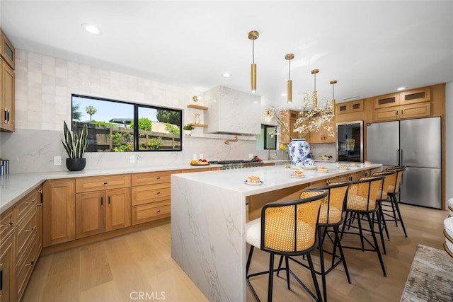 3209 Lakeknoll Dr, Fullerton, CA 92835 - kitchen with appliances with stainless steel finishes, backsplash, a kitchen breakfast bar, recessed lighting, and a center island