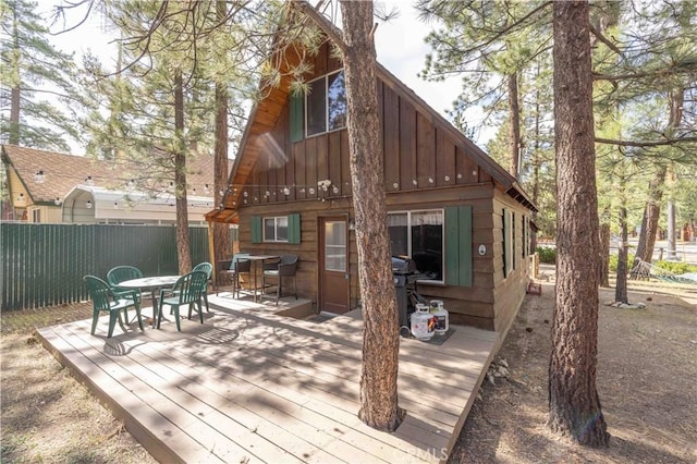 1100 Sugarloaf Blvd, Big Bear City, CA 92314 - back of property featuring outdoor dining space, board and batten siding, and a wooden deck